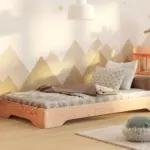 Lit simple en bois pour enfant avec matelas et coussins, dans une chambre lumineuse